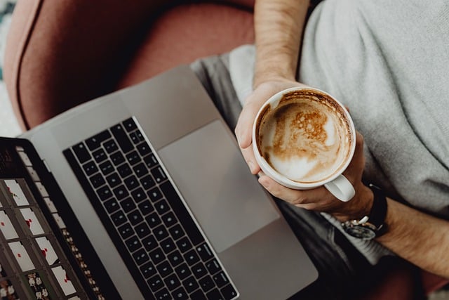 Illustration of a worker drinking coffee and working on laptop